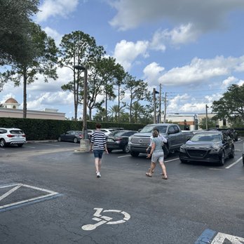Hillstone Restaurant - Patrons in shorts, t-shirts, and sandals leaving Hillstone Restaurant after having food and drink o. The back patio area. - New American Near Me - Winter Park, Florida