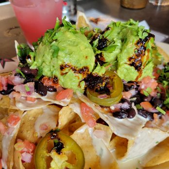 Big Star - Big Star Nachos with salsa seco drizzled on top. Some of the best quac ever! Yellow Rose Daiquiri in background (yep, it's pink). - Beer Bar Near Me - Chicago, Illinois Big Star - Big Star Nachos with salsa seco drizzled on top. Some of the best quac ever! Yellow Rose Daiquiri in background (yep, it's pink). - Beer Bar Near Me - Chicago, Illinois