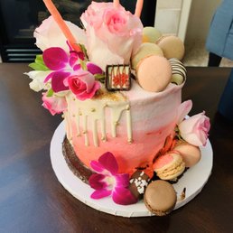 Pink cream outer layer, chocolate flavor and chocolate filling inside. Real flowers outside. Also macarons!