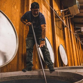 Linne Calodo - Winemaker, Farmer Matt Trevisan doing punch downs during Harvest. - Wineries Near Me - Paso Robles, California Linne Calodo - Winemaker, Farmer Matt Trevisan doing punch downs during Harvest. - Wineries Near Me - Paso Robles, California