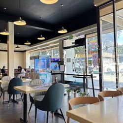 Cafe Spot - Partial interior, with a claw machine and an arcade game by the entrance.