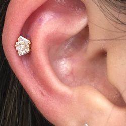 Metal & Stone - Helix piercing w yellow gold marquee by piercer Ronnie.