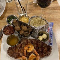 Peddler Steak House - 10oz strip steak with grilled shrimp and loaded baked potato