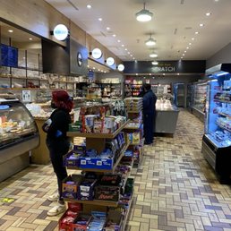 a woman standing in a grocery store a woman standing in a grocery store