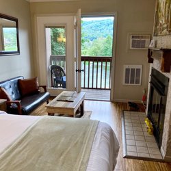LakeFront Lodge - Room 209. Second floor with one bed and a fireplace.