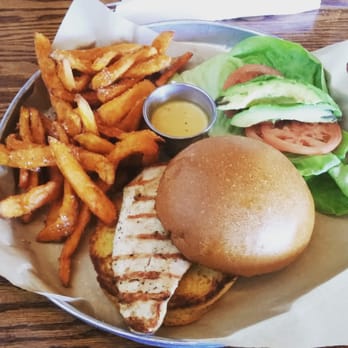 Adair Kitchen - Avocado chicken sandwich with honey mustard and sweet potato fries on the side. - New American Near Me - Houston, Texas