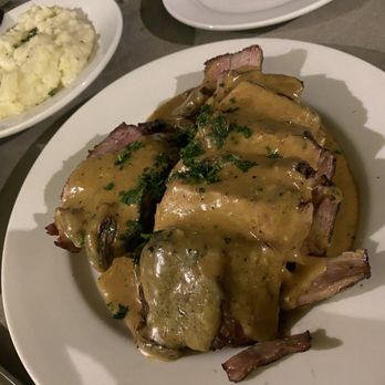 The Cutlery - Kurobuta Pork Chop with morel mushrooms.Huge portion! Truffle mashed potatoes in the background. - Steakhouses Near Me - Honolulu, Hawaii