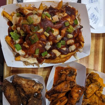Smoked Out Cincy - BBQ pork fries. Left to right wings: Jamaican dry rub, hot buffalo, and spicy garlic. - Barbeque Near Me - Cincinnati, Ohio