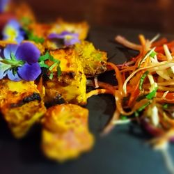 1580 - Kesar Paneer Tikka. Cottage cheese chunks marinated with saffron, creamy yogurt & spices, cooked in a tandoor oven. Served with mint sauce.