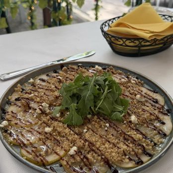 Luca Turci - Pear Carpaccio Vegetarian pear carpaccio slices topped with truffle honey, balsamic, walnuts, gorgonzola cheese and arugula - Italian Near Me - Winter Park, Florida Luca Turci - Pear Carpaccio Vegetarian pear carpaccio slices topped with truffle honey, balsamic, walnuts, gorgonzola cheese and arugula - Italian Near Me - Winter Park, Florida