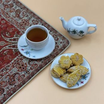 Persian Treat - a plate of cookies and a cup of tea - Desserts Near Me