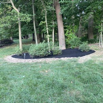 Mario’s Landscaping - a black mulch bed in a park - Lawn Services Near Me Mario’s Landscaping - a black mulch bed in a park - Lawn Services Near Me