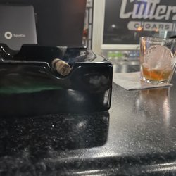 Cutters Cigars - A cigar and a nice picture of the bar with the logo on the back