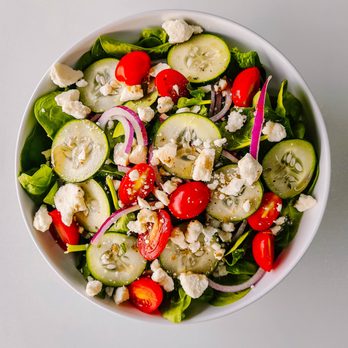 Next Door Pizza - a bowl of salad with cucumbers, tomatoes, red onions, and feta cheese - Pizza Near Me - Luxemburg, Wisconsin Next Door Pizza - a bowl of salad with cucumbers, tomatoes, red onions, and feta cheese - Pizza Near Me - Luxemburg, Wisconsin