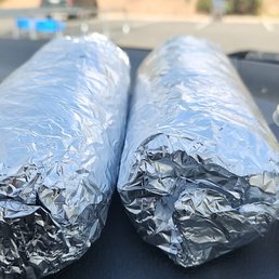 Carne asada burritos and green and red salsa. Carne asada burritos and green and red salsa.