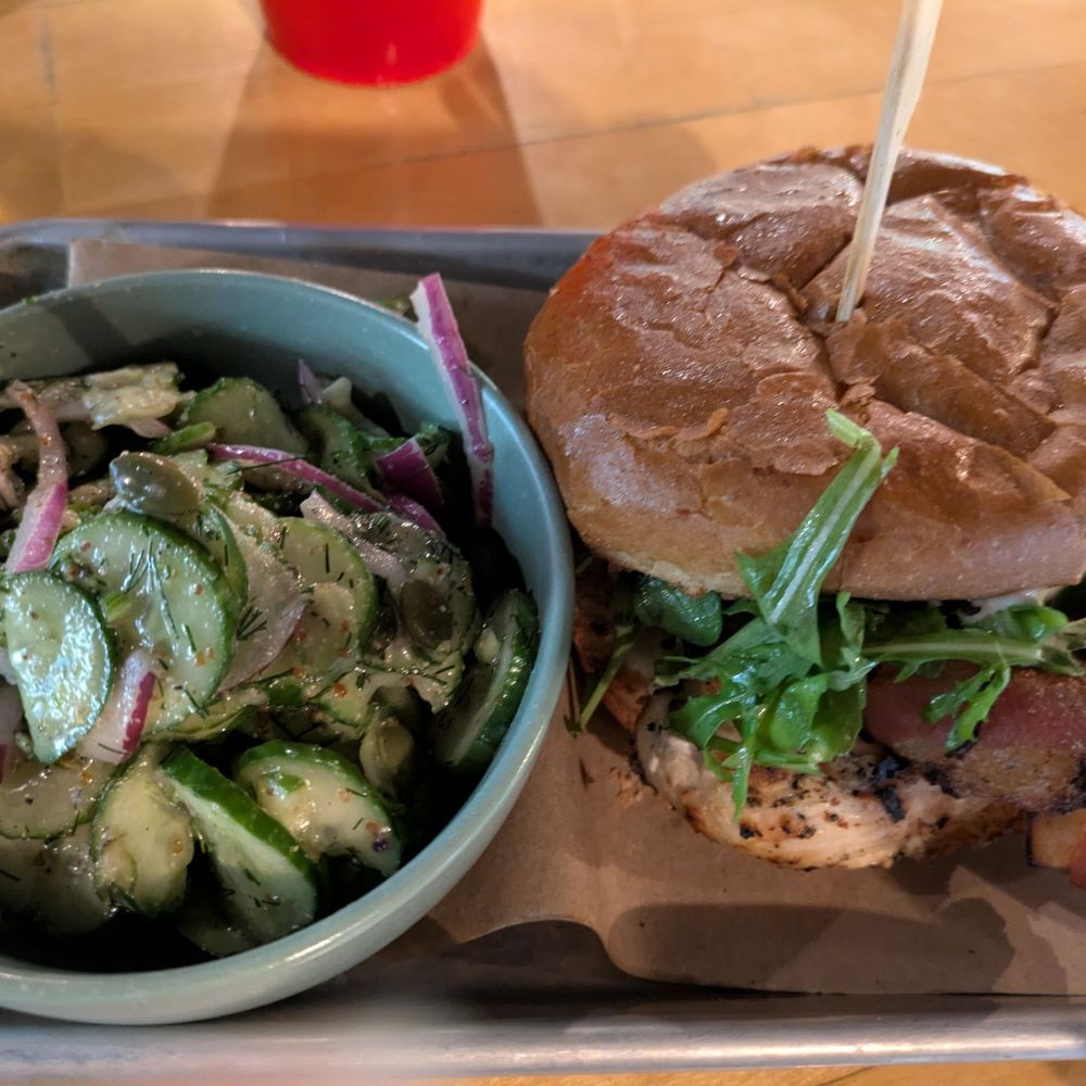 Creekhouse Kitchen & Bar - Chicken sandwich with cucumber salad - New American Near Me - Wimberley, Texas Creekhouse Kitchen & Bar - Chicken sandwich with cucumber salad - New American Near Me - Wimberley, Texas