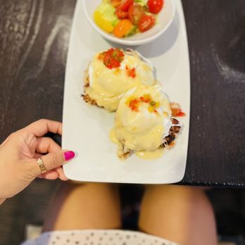 Eques - Crab Benedict with avocado salad. Chive biscuit, Dungeness crab cake, poached egg, citrus cream and avocado salad! - Breakfast & Brunch Near Me - Bellevue, Washington