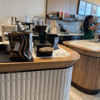 Starbucks - a coffee shop counter with coffee cups on it - Coffee & Tea Near Me - Kearney, Nebraska