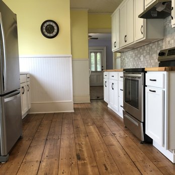 Drummer Interiors - a kitchen with white cabinets and wood floors - General Contractors Near Me - Glenmont, New York Drummer Interiors - a kitchen with white cabinets and wood floors - General Contractors Near Me - Glenmont, New York