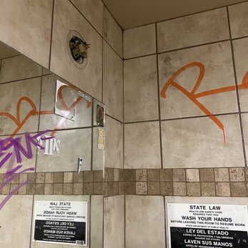 Just Wing It - a bathroom with graffiti on the walls - Chicken Wings Near Me - Bakersfield, California