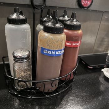 Gogiville - All of the sauces are at the table - Barbeque Near Me - Centreville, Virginia