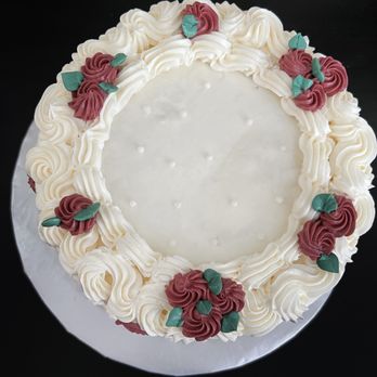 Ashley’s Sugar On Top - White cake with Raspberry filling and lemon buttercream (custom piping design) - Cupcakes Near Me