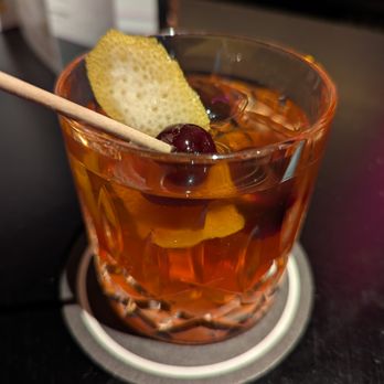 Puttshack - Perfect Old Fashioned. $19. Abasolo Ancestral Corn Whisky, orange and lemon peel, orange bitters, demerara syrup, signature ice ball. - Mini Golf Near Me - Dunwoody, Georgia