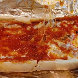 a hot dog covered in sauce and cheese a hot dog covered in sauce and cheese