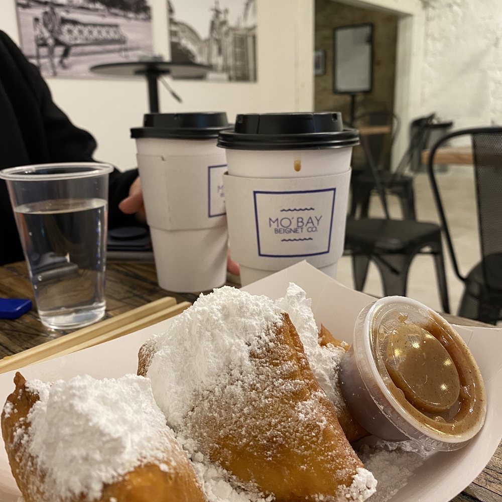 Mo'Bay Beignet - Trio of beignets with cinnamon syrup - Coffee & Tea Near Me - Mobile, Alabama Mo'Bay Beignet - Trio of beignets with cinnamon syrup - Coffee & Tea Near Me - Mobile, Alabama