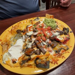 Swain Brothers - What they're known for- the T-Rex Nachos. Be sure to share these, they're huge.