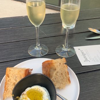 Juniper - Two glasses of champagne for our anniversary with complimentary bread and butter soooo good - Italian Near Me - Austin, Texas