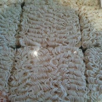 IPPUDO NY - Dry ramen bricks under glass make up the bar. Very cool. - Ramen Near Me - New York, New York