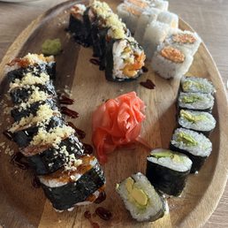 From bottom left to right clockwise. Sweet potato roll, tempura shrimp roll, spicy crab roll, and avocado roll.