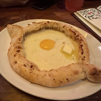Deda Restaurant - Adjaruli Khachapuri (cheese filled bread boat with egg yolk) - Georgian Near Me - Pasadena, California Deda Restaurant - Adjaruli Khachapuri (cheese filled bread boat with egg yolk) - Georgian Near Me - Pasadena, California
