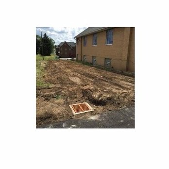 Leaktight - a picture of a drain in the middle of a street - General Contractors Near Me - Canton, Ohio Leaktight - a picture of a drain in the middle of a street - General Contractors Near Me - Canton, Ohio