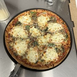 Gionino's Pizzeria of Carrollton - Caprese Pizza (Thin crust, red sauce, spinach, tomato, basil, mozzarella, provolone and Parmesan cheese.