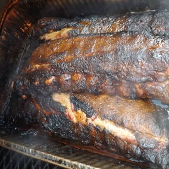 Copney's BBQ - a close up of ribs cooking in a smoker - Barbeque Near Me - Spring Church, Pennsylvania Copney's BBQ - a close up of ribs cooking in a smoker - Barbeque Near Me - Spring Church, Pennsylvania