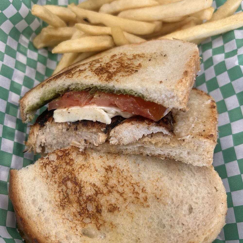 Grilled chicken pesto sandwich on sourdough. Grilled chicken pesto sandwich on sourdough.