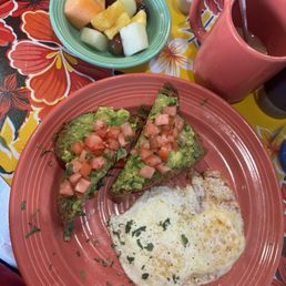 Avo toast, I asked the kitchen to add cilantro. Over easy egg and fruit. Avo toast, I asked the kitchen to add cilantro. Over easy egg and fruit.