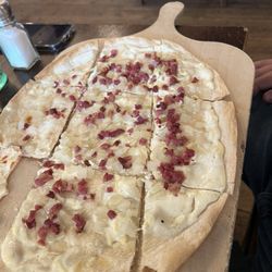 Bitburger Wirtshaus - Flammkuchen. This crust with a sour cream sauce and bacon and onions