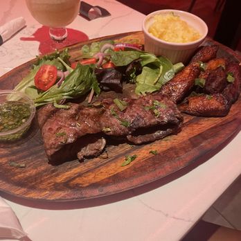 Caoba Restaurant & Lounge - PAPI STEAK CHURRASCO Hand-cut 12 oz skirt steak topped with chimichurry sauce. - Latin American Near Me - Orlando, Florida Caoba Restaurant & Lounge - PAPI STEAK CHURRASCO Hand-cut 12 oz skirt steak topped with chimichurry sauce. - Latin American Near Me - Orlando, Florida
