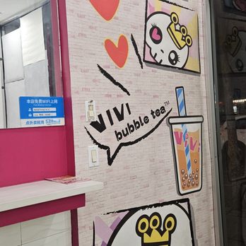 ViVi Bubble Tea - Wall is cover Sugar skull female character appears ubiquitous on their cups, drink sealant lid, and wall decor who is wearing pink - Bubble Tea Near Me - New York, New York ViVi Bubble Tea - Wall is cover Sugar skull female character appears ubiquitous on their cups, drink sealant lid, and wall decor who is wearing pink - Bubble Tea Near Me - New York, New York