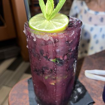 El Arriero Mexican Restaurant - a purple drink with a lime garnish - Mexican Near Me - Jacksonville, North Carolina