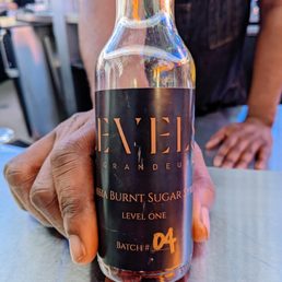 a person holding a bottle of alcohol a person holding a bottle of alcohol