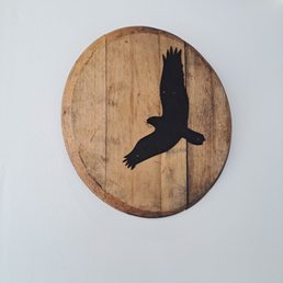 a bird on a wooden plaque