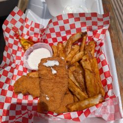 Delicious chicken fingers and french fries having lunch. Golden eagle big reds. Delicious
