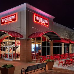 Taco Bamba Fair Lakes - Exterior shot of the restaurant located in the corner of a shopping mall with two large lit signs saying "Taco Bamba" with a ...