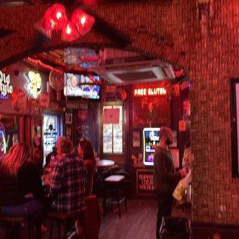 Red Door Saloon - a group of people sitting at a bar - Bars Near Me - Nashville, Tennessee