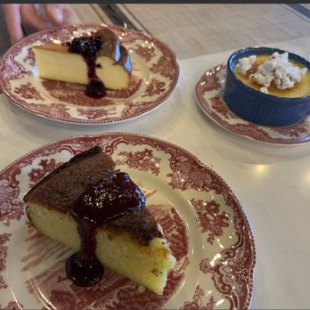 Bramble - 11am clockwise: Basque Cake with berry compote, Popcorn Crème Brûlée, Lemon Olive Oil Cake with stone fruit compote & Meyer lemon - Pizza Near Me - Essex, Vermont