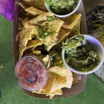 Taqueria Anita - a person holding a box of chips and guacamole - Tacos Near Me - Delray Beach, Florida Taqueria Anita - a person holding a box of chips and guacamole - Tacos Near Me - Delray Beach, Florida